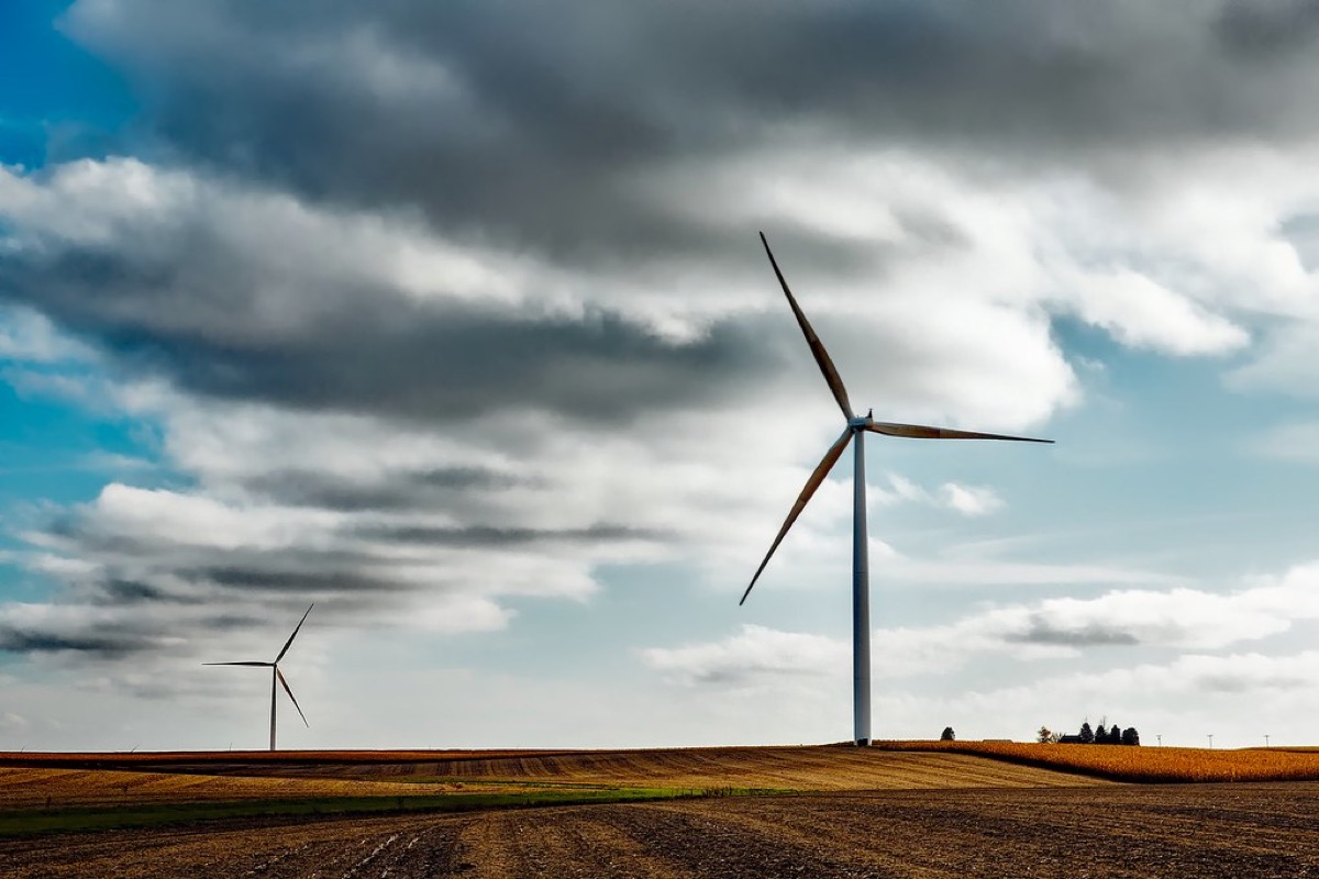 A wind turbine against a cloudy sky